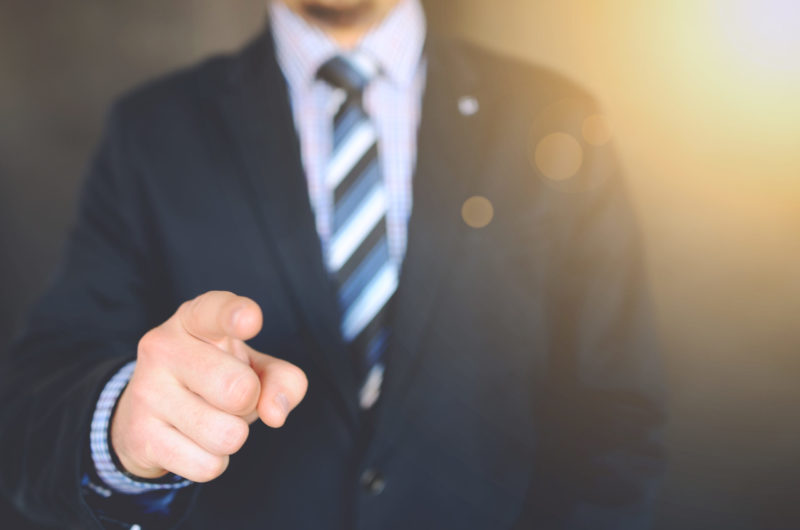 man in suit pointing