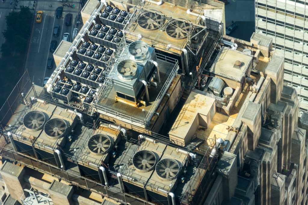 air conditioning units on the roof of a tall building