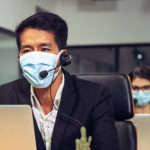 Young telephone operator with headset wear protection face mask against coronavirus, Customer service executive team working at office