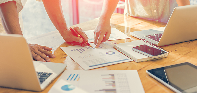 Business people analyzing investment charts. Accounting , with soft focus, vintage tone