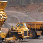 Off-Highway trucks parked in gravel pit.