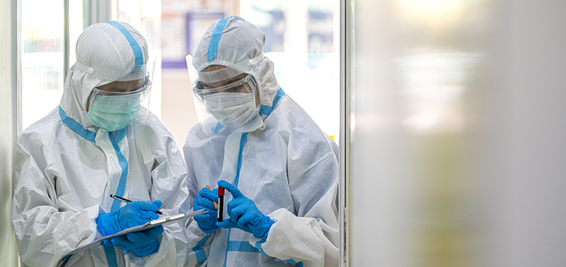 Doctors show corona or covid-19 blooding tube wearing ppe suit and face mask in hospital. Corona virus, Covid-19, virus outbreak, medical mask, hospital, quarantine or virus outbreak concept