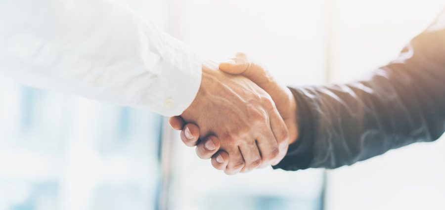 Business partnership meeting. Picture businessmans handshake. Successful businessmen handshaking after good deal. Horizontal, blurred