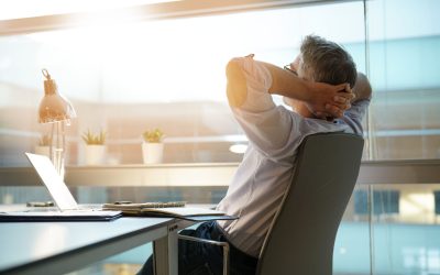 Businessman in office relaxing in chair