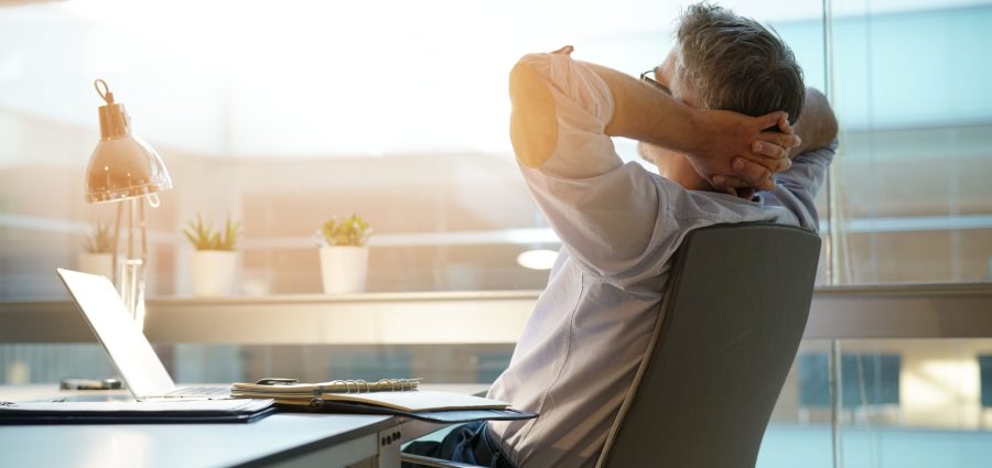 Businessman in office relaxing in chair