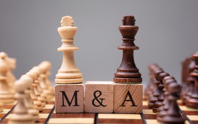 Close-up Of King Chess Pieces On Wooden Blocks With Mergers And Acquisitions