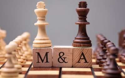 Close-up Of King Chess Pieces On Wooden Blocks With Mergers And Acquisitions