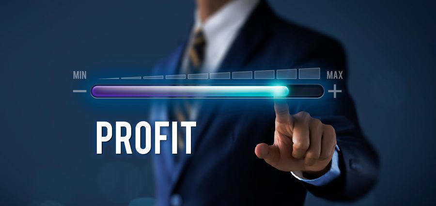 Profit growth, increase profit, raise profit or business growth concept. Businessman is pulling up progress bar with the word PROFIT on dark tone background.