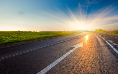 black asphalt road with arrow to sunset