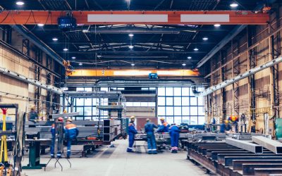 Large factory hall, blue-collar workers at work. Shipyard, heavy industry