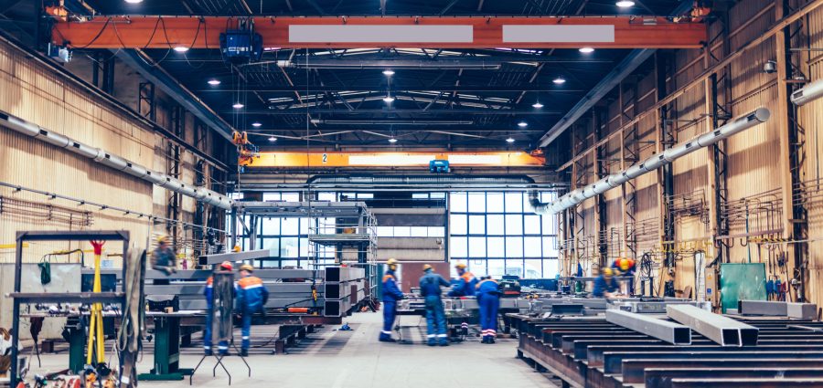 Large factory hall, blue-collar workers at work. Shipyard, heavy industry