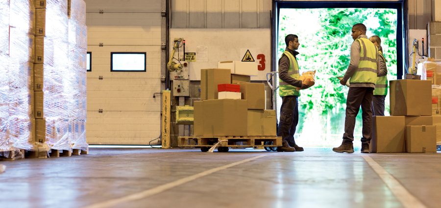 Workers talking in warehouse