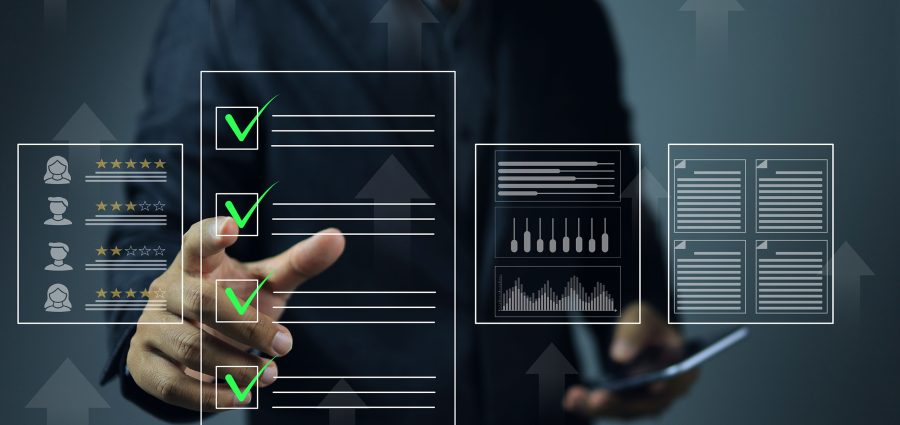 A businessman click green check mark to evaluating a vendor or supplier industrial facility and rated a maximum of five stars according to the ISO documentation management system