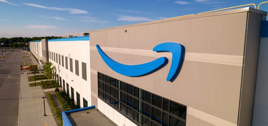 Toronto, Ontario, Canada - September 11, 2022: Amazon logo on the new build modern building. Amazon Smile Arrow logo and brand trademark. Fulfillment center warehouse and office building.