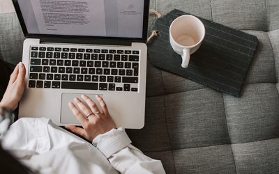 Canva - Crop woman using laptop on sofa at home