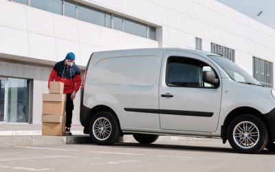 Delivery Man With Boxes next to a White Van