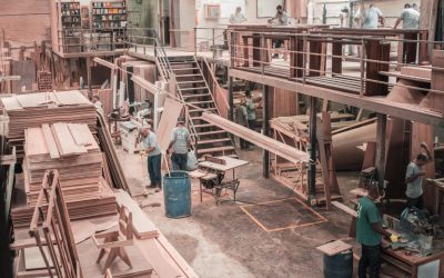 people working with lumber on a manufacturing floor