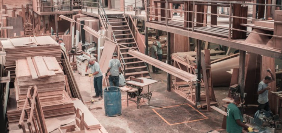 people working with lumber on a manufacturing floor