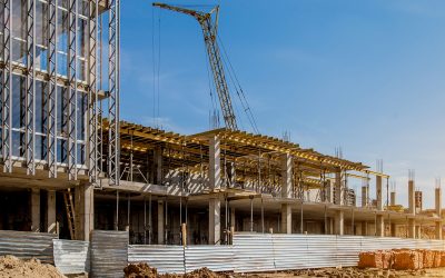 Construction site background. Hoisting cranes and new multi-storey buildings. I.ndustrial background.Building construction site work against blue sky