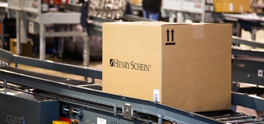 health care distributor Henry Schein box on conveyor belt