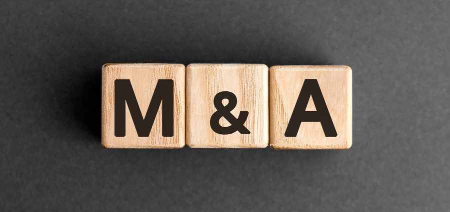 M&A - acronym from wooden blocks with letters, mergers and acquisitions M&A concept,  top view on grey background