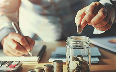 businessman saving money concept. hand holding coins putting in