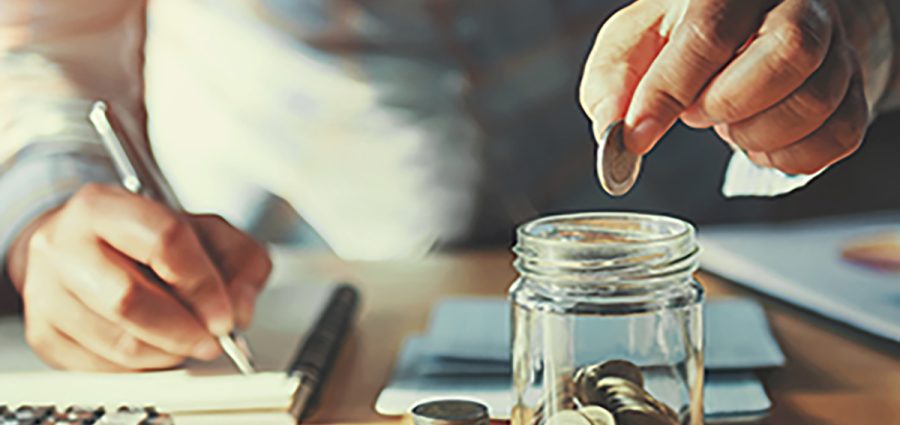 businessman saving money concept. hand holding coins putting in