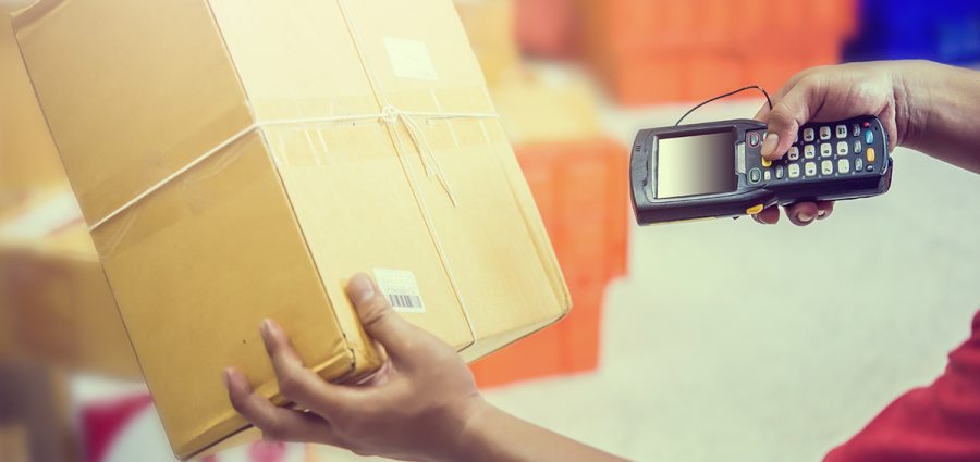 Worker Scanning Package In Warehouse