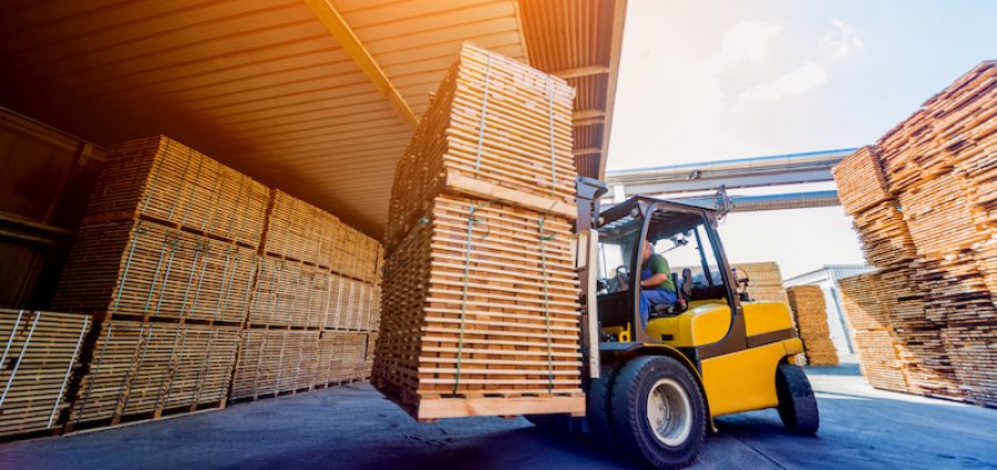 Forklift loader load lumber into a dry kiln. Wood drying in containers.