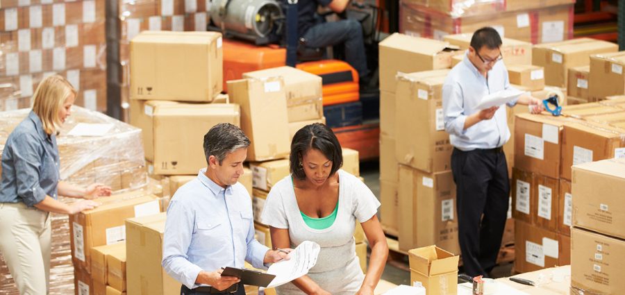 Workers In Warehouse Preparing Goods For Dispatch