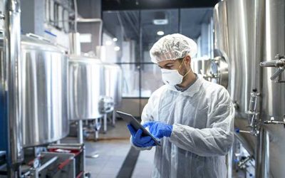 man in lab working with tablet and chemicals