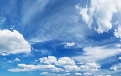 white fluffy clouds on blue sky in summer on sunny day. Beautiful cloudscape background