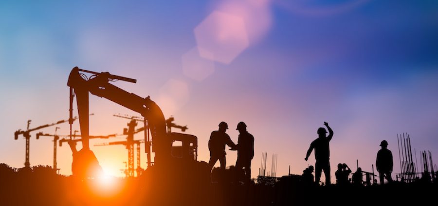 Silhouette of engineer and construction team working at site over blurred background for industry background with Light fair.Create from multiple reference images together