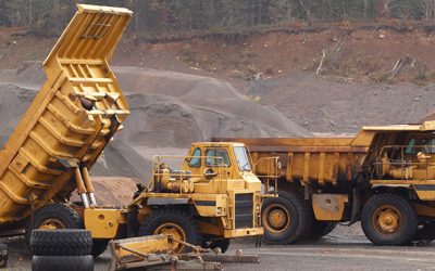 Off-Highway trucks parked in gravel pit.