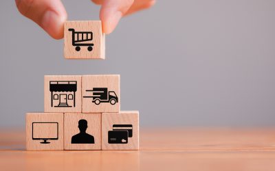 Concept add to cart, Online shopping, ecommerce and delivery service. The hand holds a wooden cube with icons - trolley, market, delivery, computer, customer and payment. Close up.