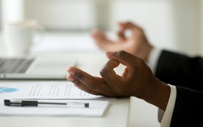 African american calm businessman relaxing meditating in office, peaceful ceo in suit practicing yoga at work, focus on black man hands in mudra, successful mindful people habits concept, close up