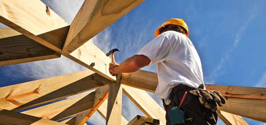 roofer ,carpenter working on roof structure at construction site