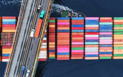 A container ship passes beneath a suspension bridge as it departs for Europe.