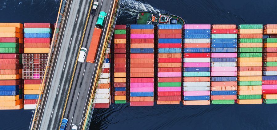 A container ship passes beneath a suspension bridge as it departs for Europe.