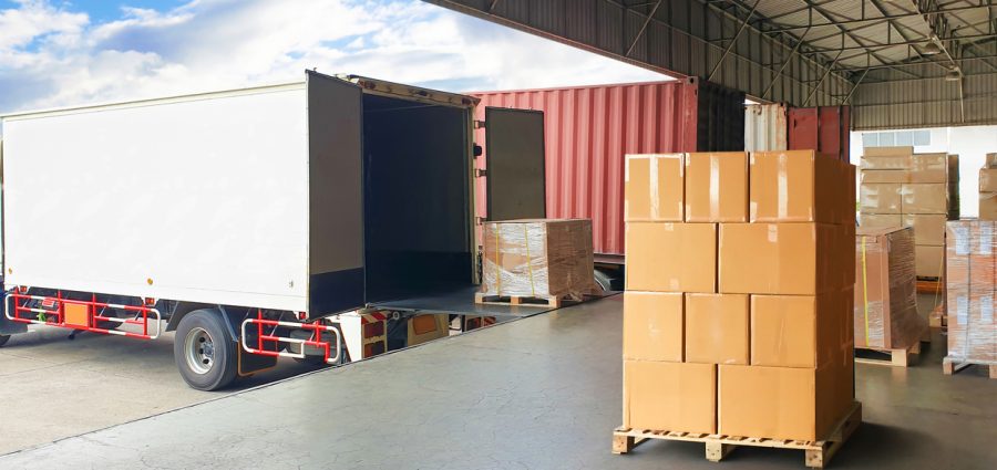 Package Boxes Stack on Wooden Pallets Loading into Container Trucks. Distribution Supplies Warehouse Shipping. Supply Chain, Shipment. Freight Truck Logistic, Cargo Transport.