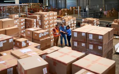 Shot of people at work in a large warehouse full of boxes