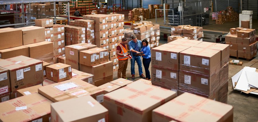 Shot of people at work in a large warehouse full of boxes