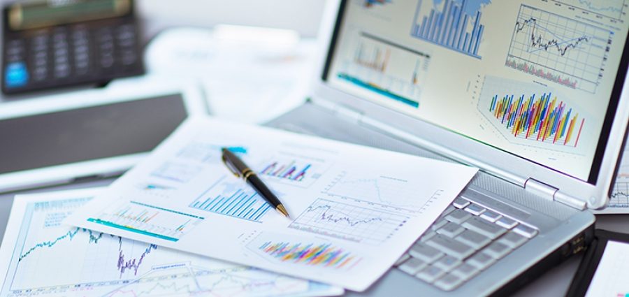 Businessman analyzing investment charts with laptop. Revenue management.