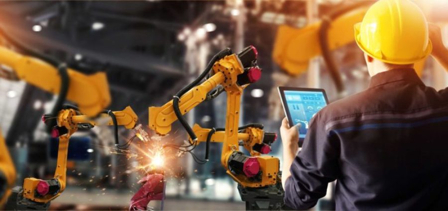 person working with robotic arms and tablet