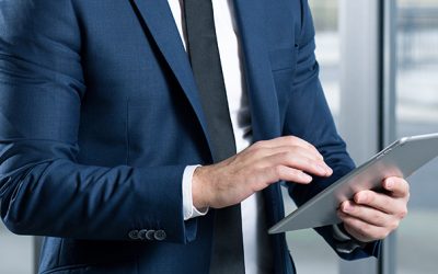 Businessman wearing suit and tie using his tablet