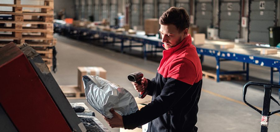 Courier picks up package on a warehouse.