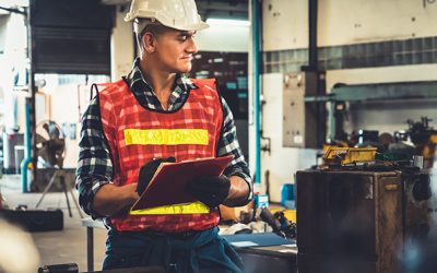 Manufacturing worker working with clipboard to do job procedure checklist .